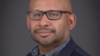 Professional portrait of Dr. Kevin Valaderes, health administration professor