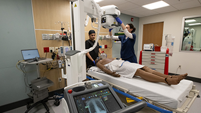 student using portable X-ray machine