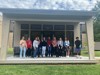 a group of student stand outside the Minka House on USI's campus