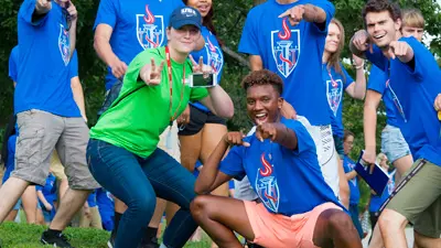 Students in casual USI logo wear make a goofy pose