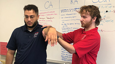 OT student teaching range of motion to nursing student