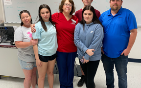 Susan with photo with parents and children who were in car accident