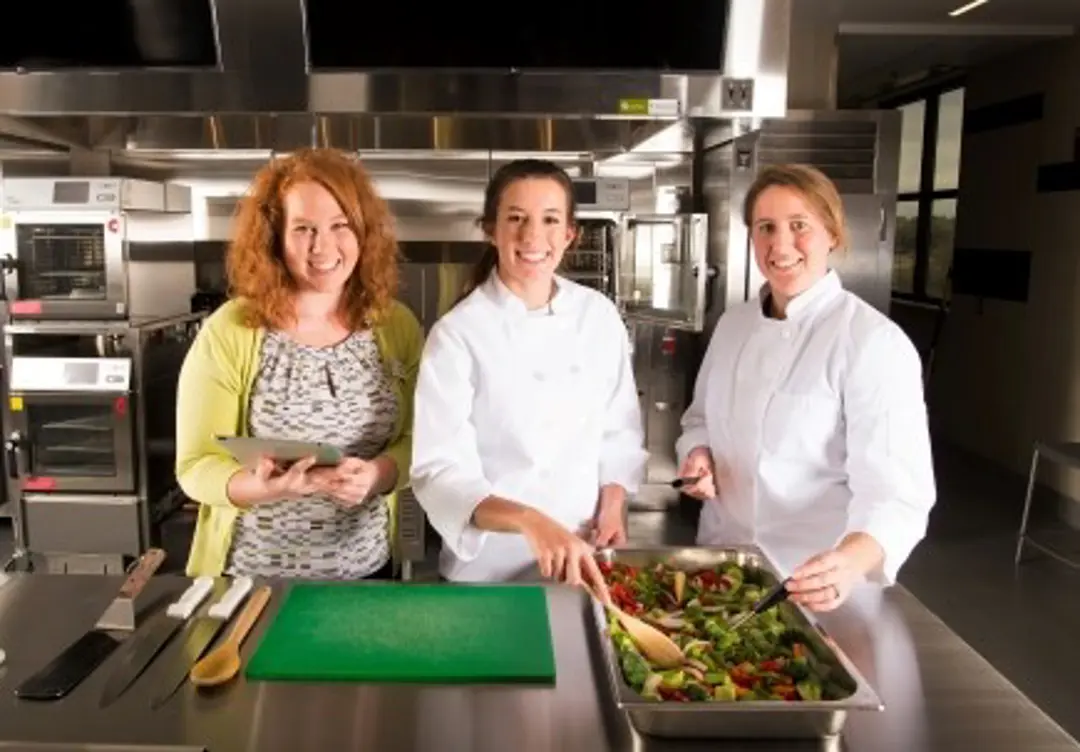 photo of three students in food and nutrition kitche