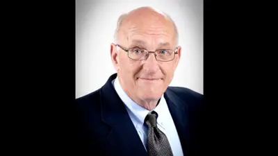 Professional portrait of Dr. Robert West, assistant professor emeritus of Advertising