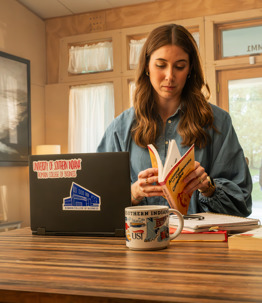 Student reading a book at the table