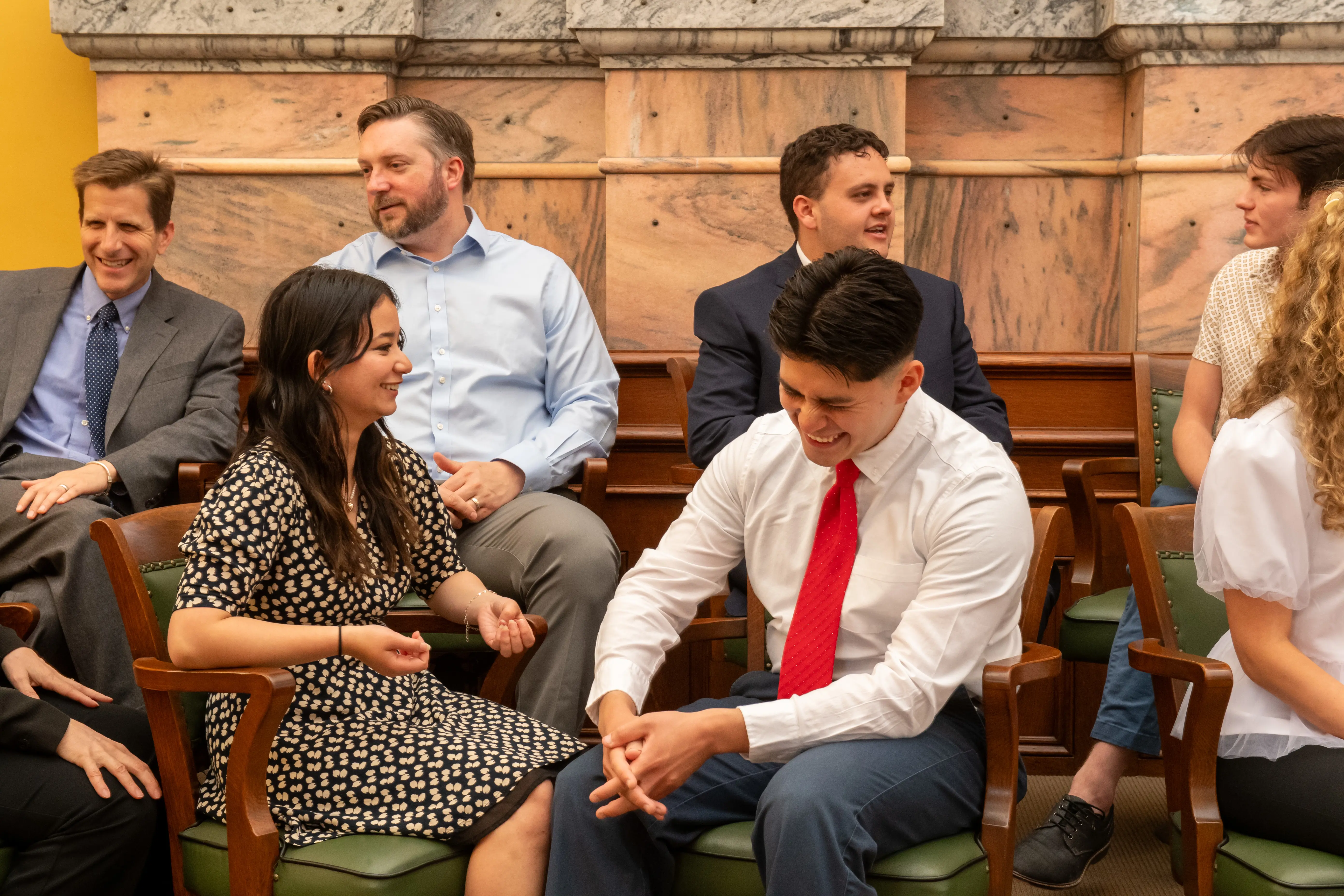 Students and faculty laugh and smile together at the Vanderburgh County Courthouse