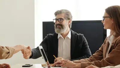 A group of people communicate in a work setting.