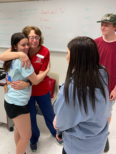 Photo of Susan Seibert hugging the teen she helped