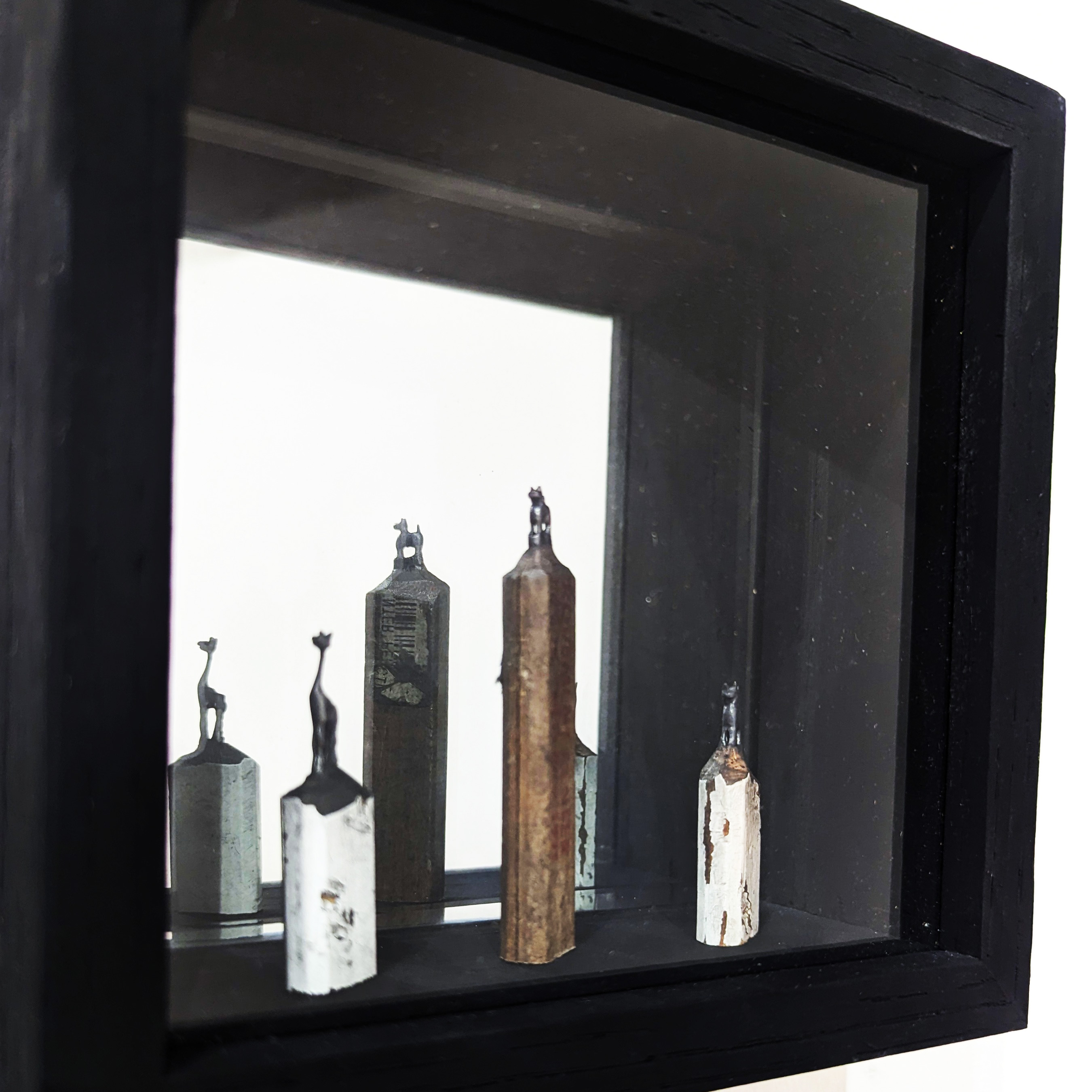 Artwork of cat sculptures in a shadowbox