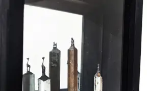 Artwork of cat sculptures in a shadowbox