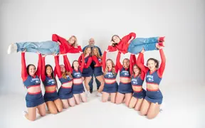 Members of the USI cheer team lift their two long-time coaches in the air. 