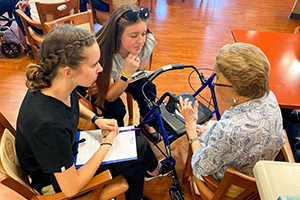 photo of occupational therapy assistant students with an older adult