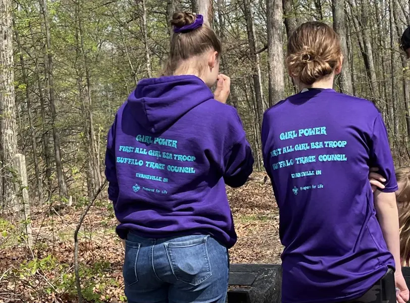 A Girl Scout Troop, also a Scouting Troop pause after installing a bench on the Bent Twig Trail