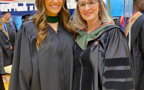 MHA student and faculty member in cap and gown