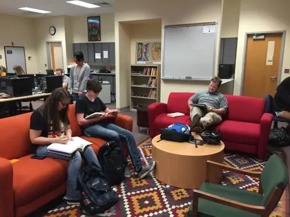 USI world languages students sit in the seating area of the Miller Language Lab and study