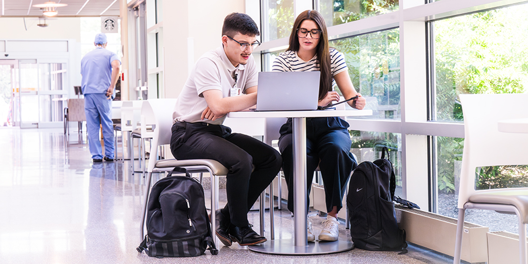 Two students looking at laptop