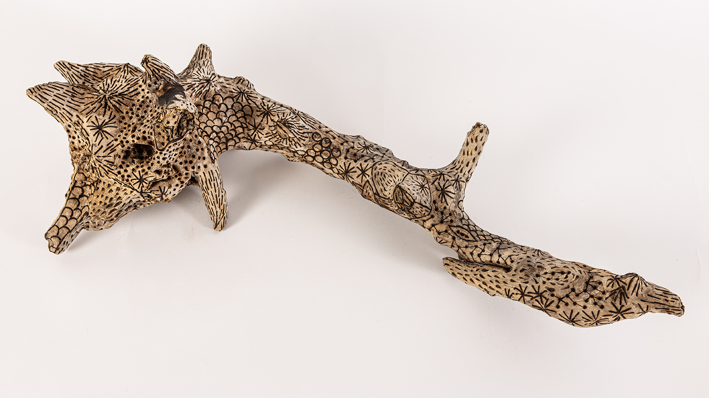 tattooed wood art piece