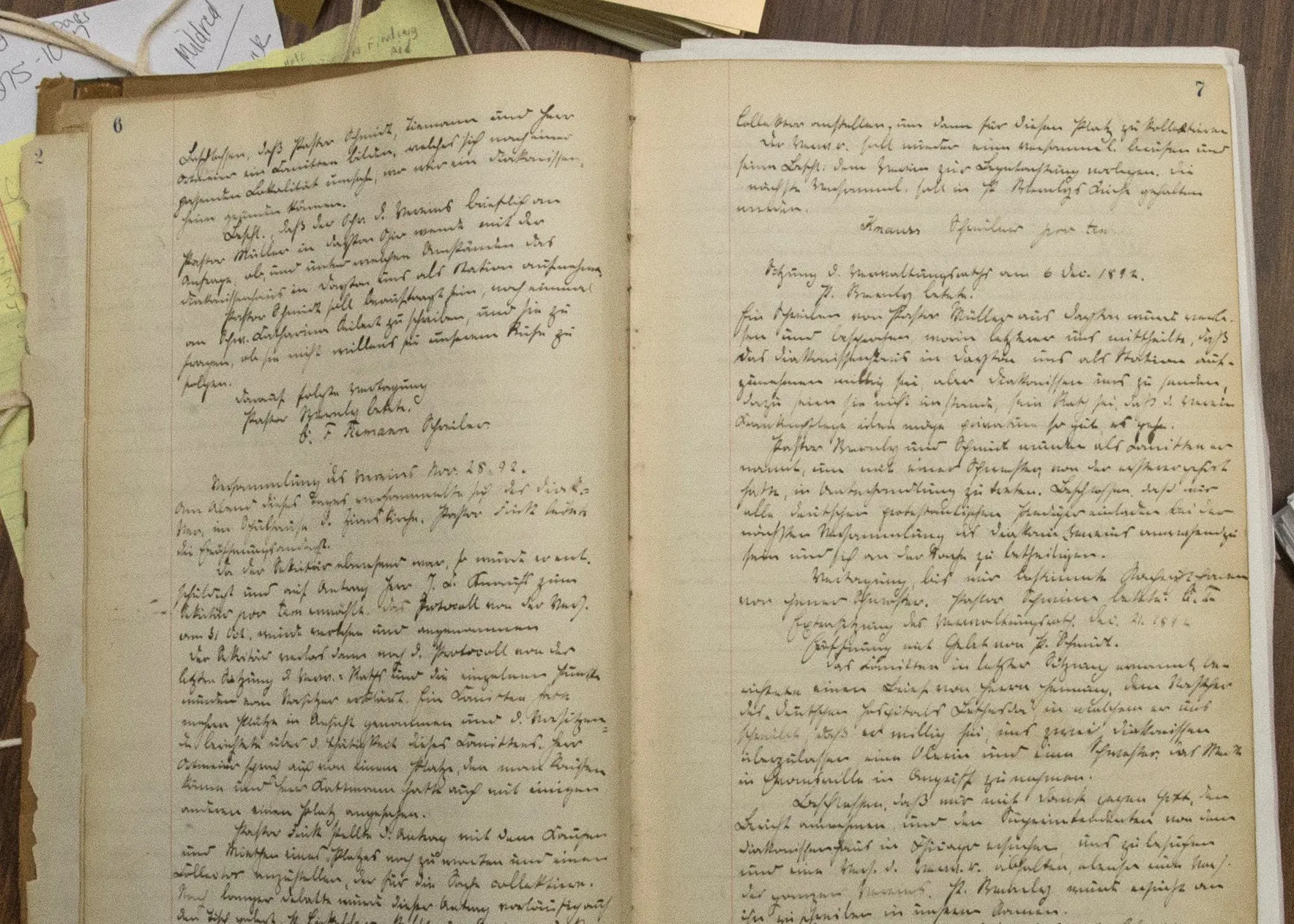 An old book opened with yellowing pages and handwritten script text