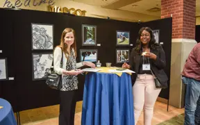 USI psychology faculty member poses with a student at an event