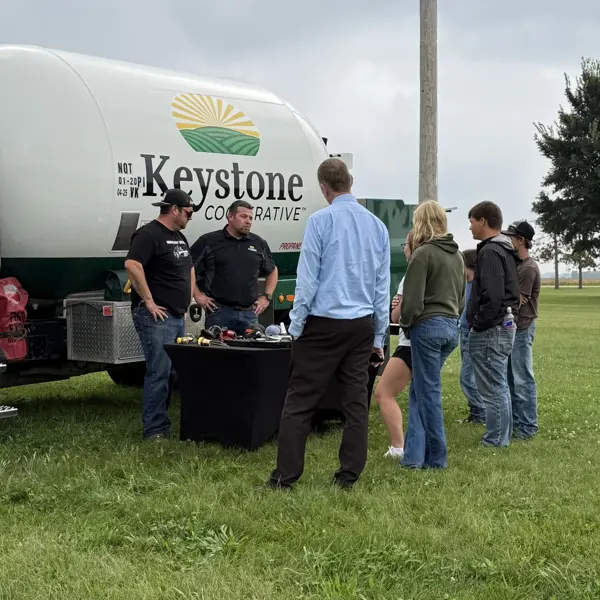 Students engage with Keystone Cooperative representatives during an outdoor agricultural education demonstration.