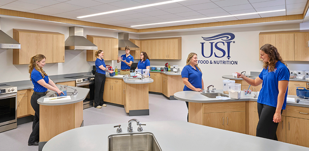 Students and faculty working in the kitchen in the lower level of Health Professions Center