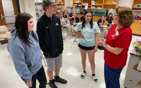 Student talking with teens who visited her class