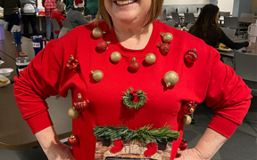 Staff member in elf hat and ugly sweater