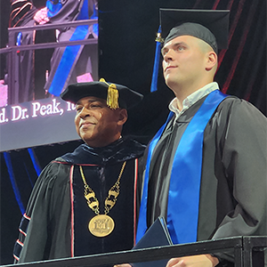 Photo of Dalton Mills and USI President at Graduation