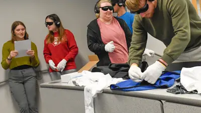 Students practice activities of daily living while simulating hearing and vision loss
