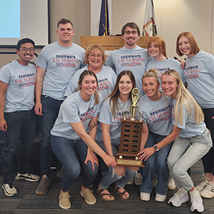 Nursing students holding a trophy